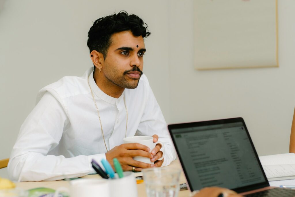 a man sitting in front of a laptop computer