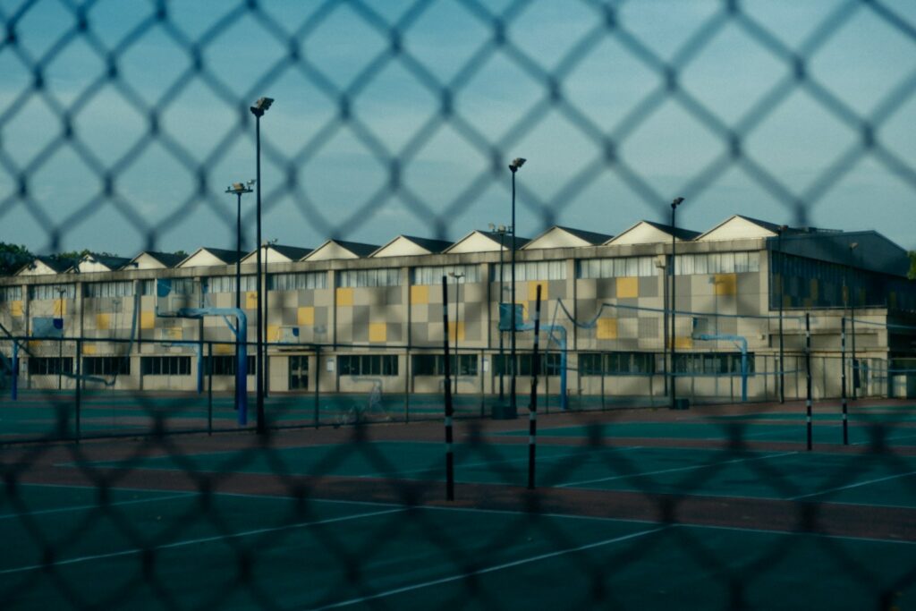 A view of a tennis court through a fence