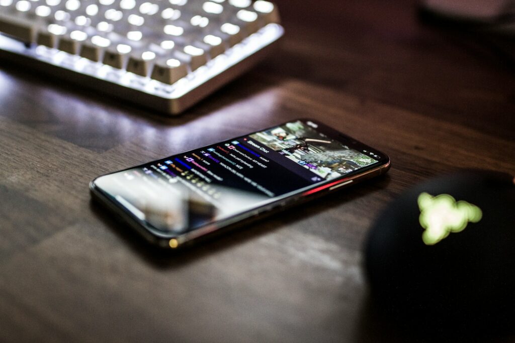 closeup photo of turned on smartphone near keyboard